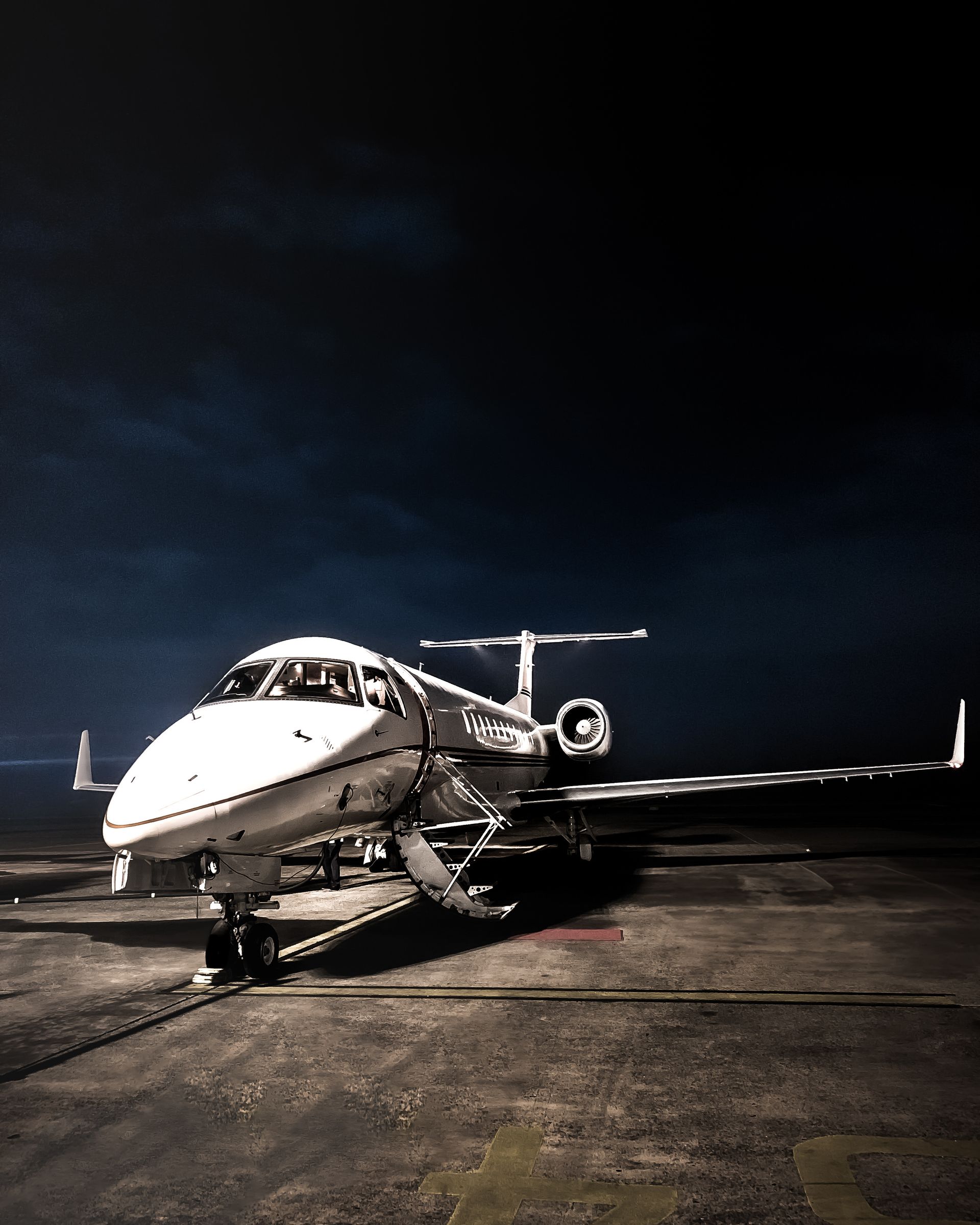 Private jet on a night-lit tarmac